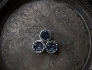 3 tins of Ritual Aromatics Sandhi Natural Depodorant Powder on a vintage silver tray