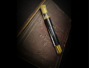 Ritual Aromatics Tea Ceremony Japanese Incense Sticks in a glass vial on an antique leather bound book