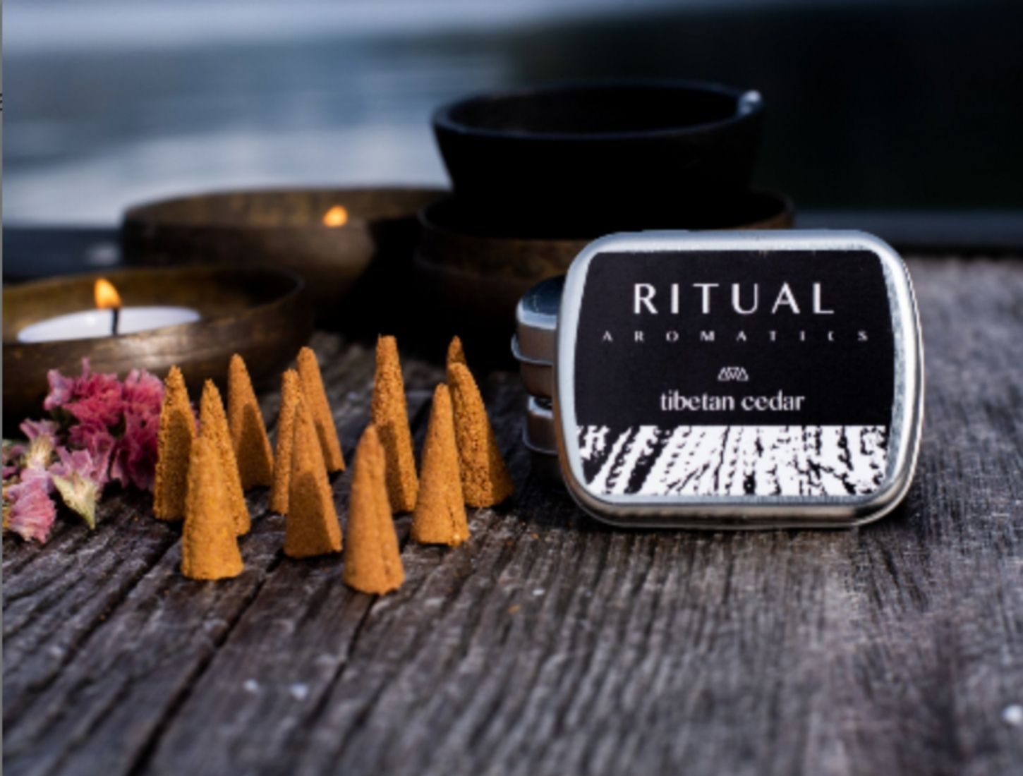 Ritual Aromatics Tibetan Cedar Artisan Incense Cones on a dock with candles in brass bowls
