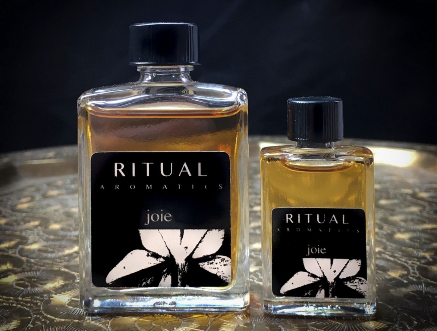 Ritual Aromatics Joie Natural Perfume 5ml and 15 ml bottles on a brass tray 